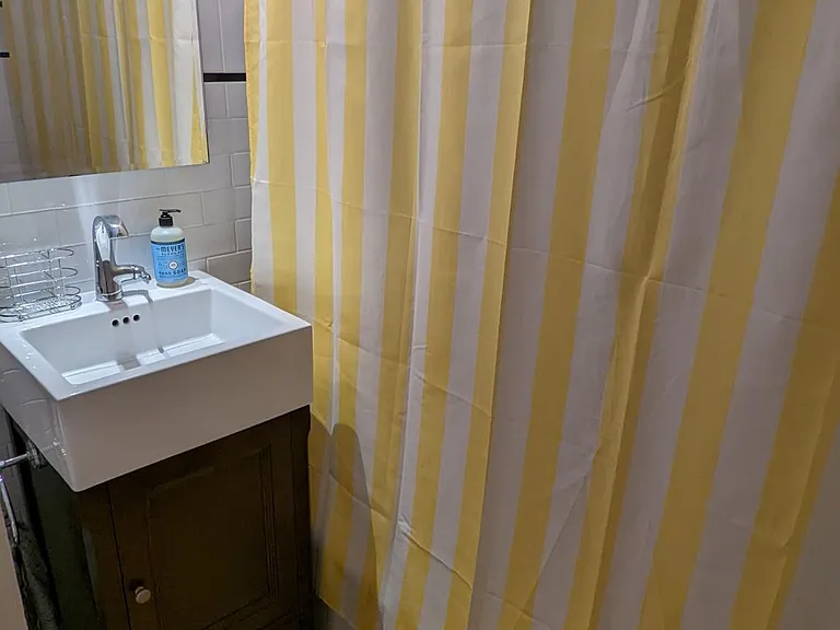 Full size bathtub, vanity with storage