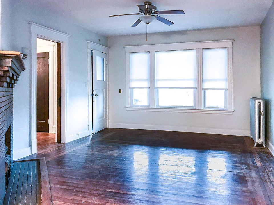 Living room with bedroom off of it. Front door of the apartment is off the living room.