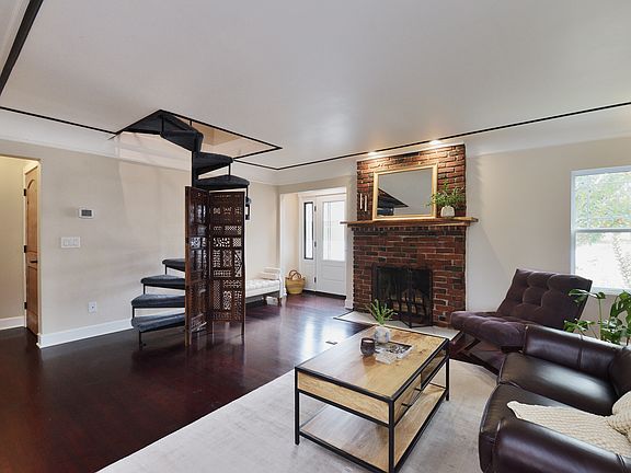 1st Floor - Living Room (w/ Entry to Main Bedroom & Spiral Staircase to Attic Rooms)