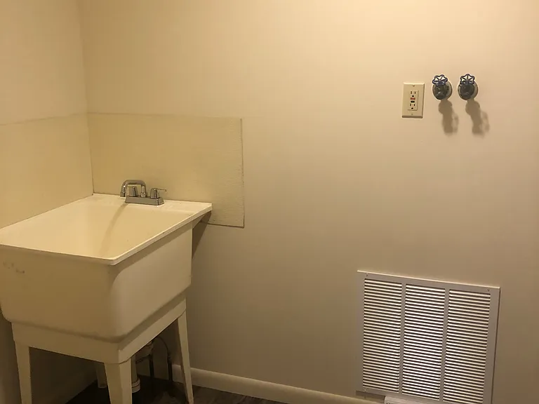 Laundry off kitchen with laundry tub. Room size is 9' x 6'.