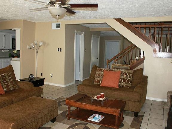 Open floor plan with ceramic tile and ceiling fan.