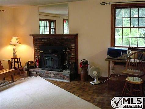living room with wood stove in fireplace