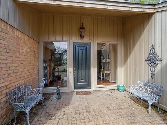 Covered brick paver porch says welcome to our home