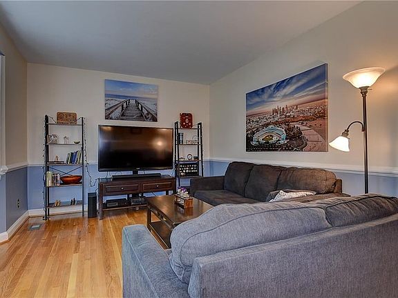 Formal living room to the left of the front door. Beautiful hardwood floors.