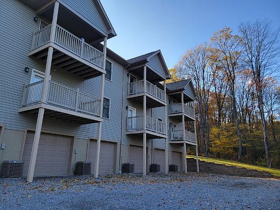 Back of apartment complex, each has a balcony and garage under each. Lots of guest parking here.