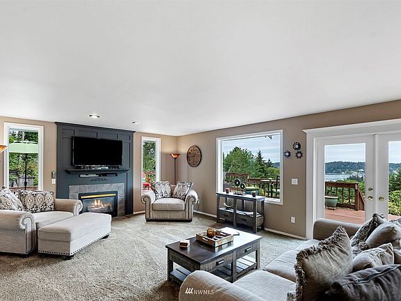 Enjoy gorgeous views of the Puget Sound while you cozy up next to the fireplace for movie night or with a good book.>