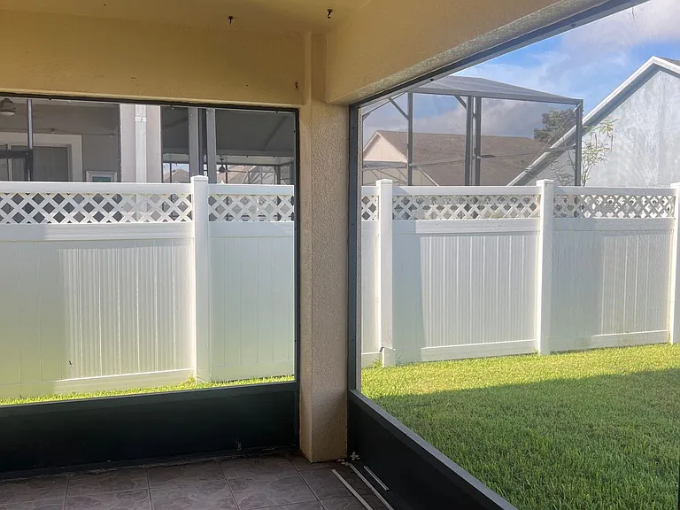 44 - Screened-in back patio overlooking the fenced yard.