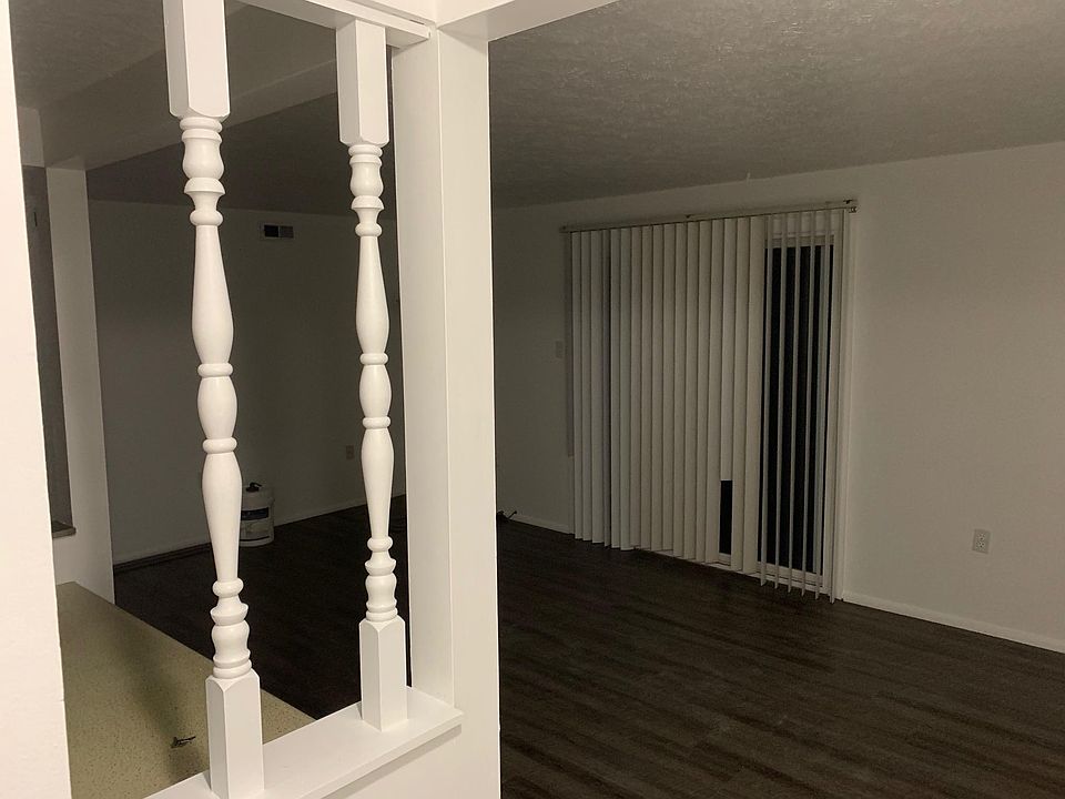 LIVING AREA WITH PATIO DOOR AND NEW LAMINATE FLOORING.