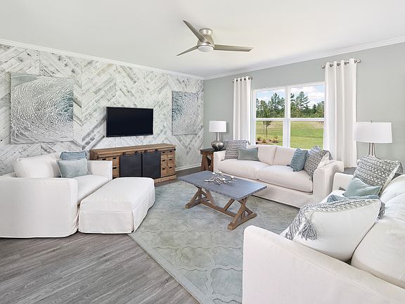 A cozy Gathering Room with accent wall offers space for everyone to be comfortable.