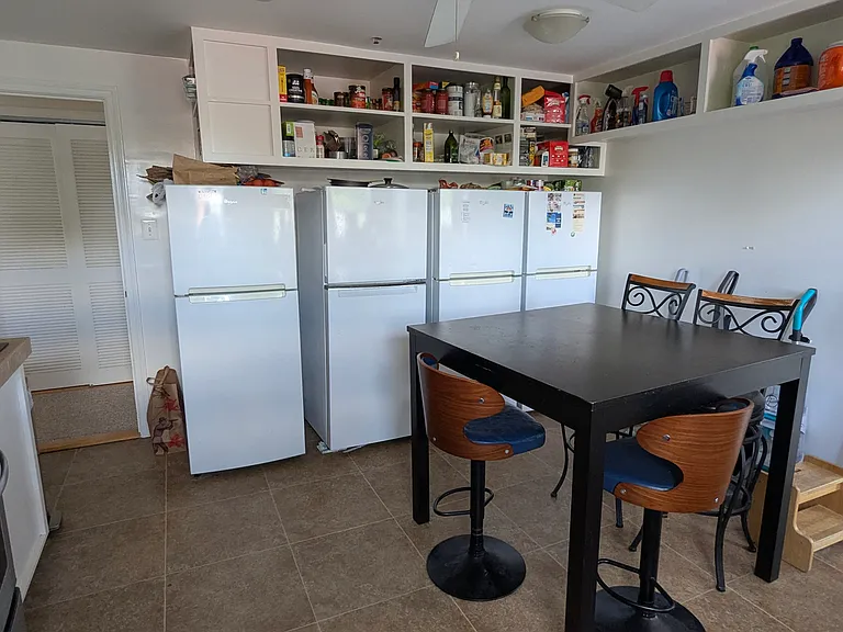 Kitchen showing refrigerators and storage space