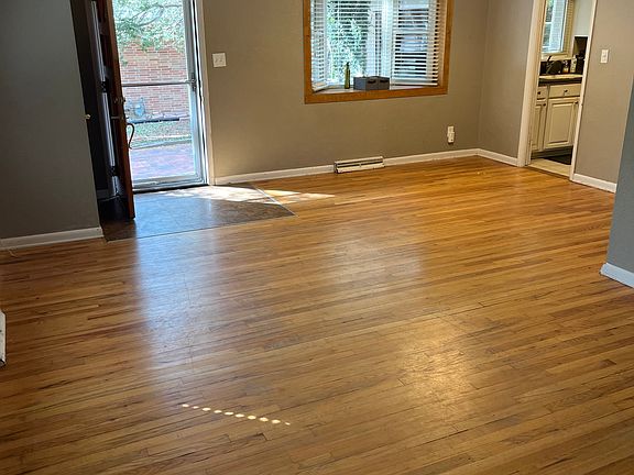 Very large living with lots of windows including a bay window.