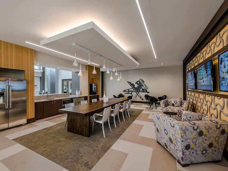 Resident lounge with entertaining kitchen, dining area with seating and flat screen televisions