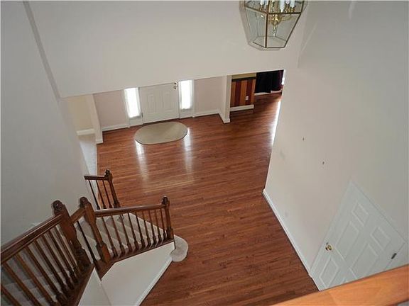 Two story hardwood entrance foyer