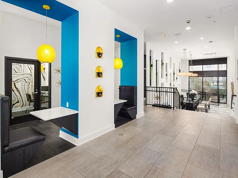 Colorful Coworking Alcoves with Built-In Seating and Pendant Lighting