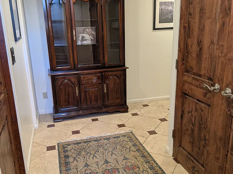 Hallway on the Garden Level, the location of a private Suite (bedroom, private bath, gas fireplace, heated bathroom tiles, closets, refrigerator and its own washer dryer. Access the laundry room, bonus rooms and 1 car garage