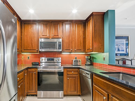 Modern stainless appliances, cherry cabinetry, well equipped kitchen