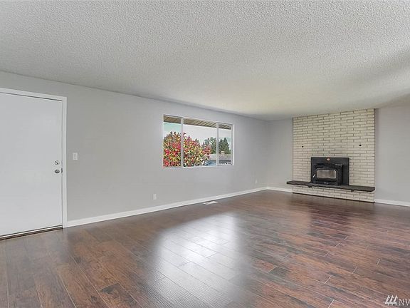 Step into your large living room with new, durable and easy-care laminate flooring! Fireplace has a blower fan can easily and efficiently heat the living room!