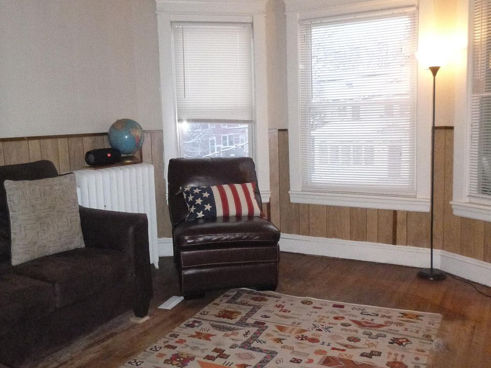 Large living room with closed-in sun porch off to right.