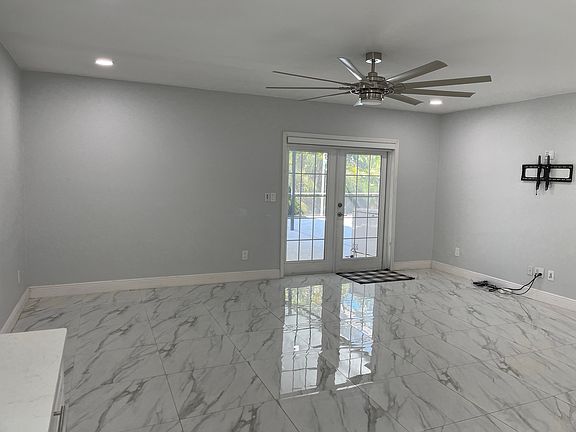 Bright and spacious living room with modern tile flooring.