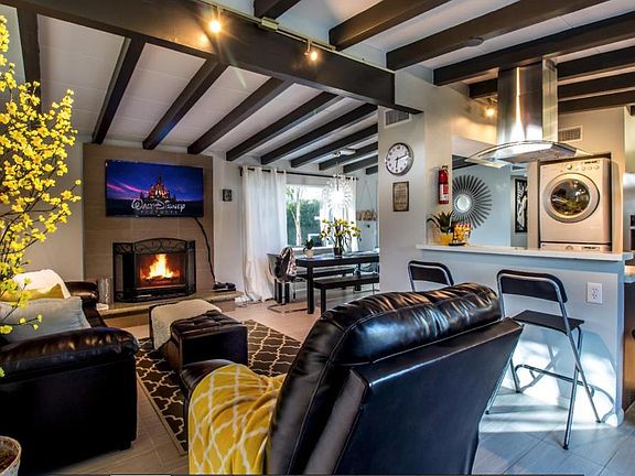 Living room with large flat screen tv and fireplace to keep
