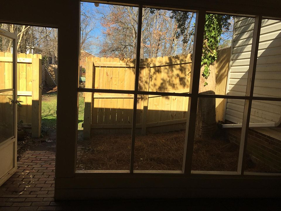 Photo taken through rear screened patio onto fenced area