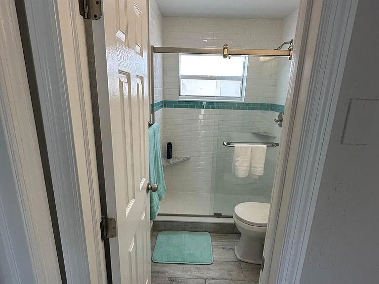 Brand new squeaky clean bathroom with elegant glass shower.