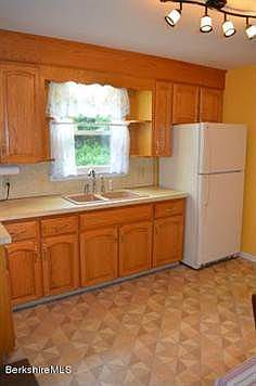 Lots of cabinets in ample sized Kitchen