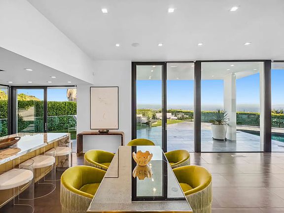 Sophisticated dining space, seamlessly blending with the outdoor view.