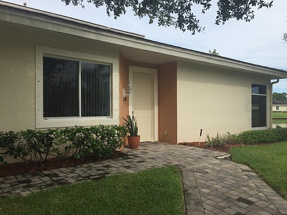Corner lot townhome with lake and park-like views off of the master bedroom, living room, and screened porch.