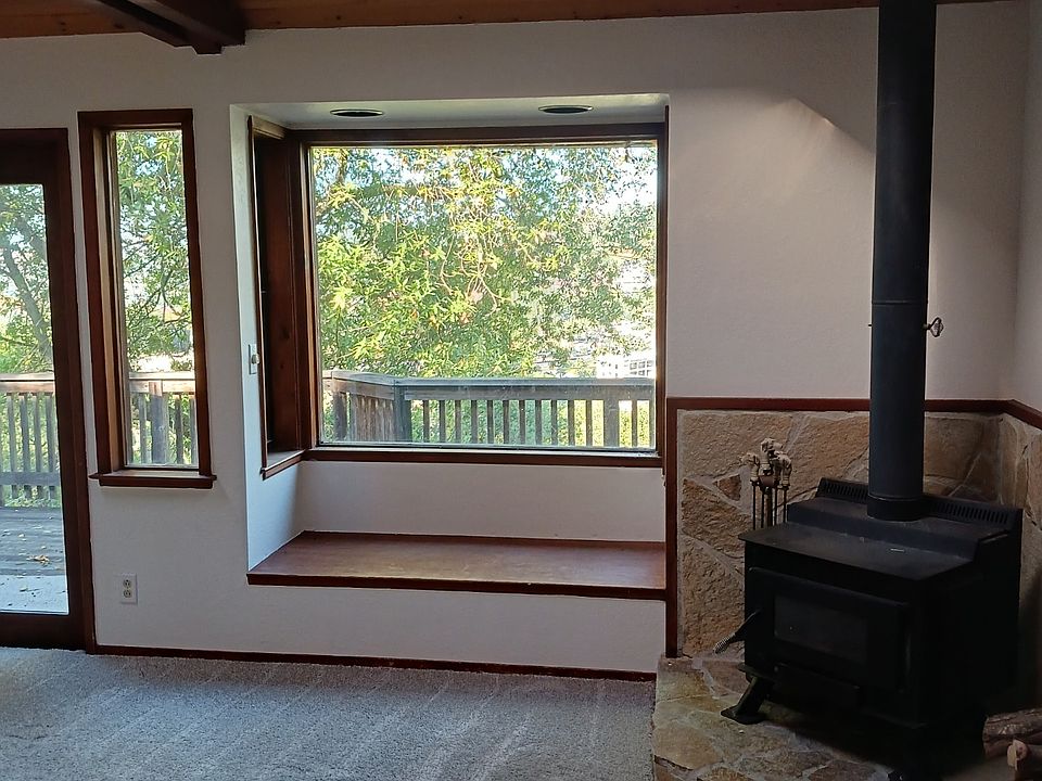 Cozy wood burning fireplace and the view out to the front deck