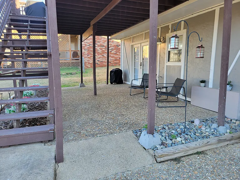 Large covered patio with seating and grill