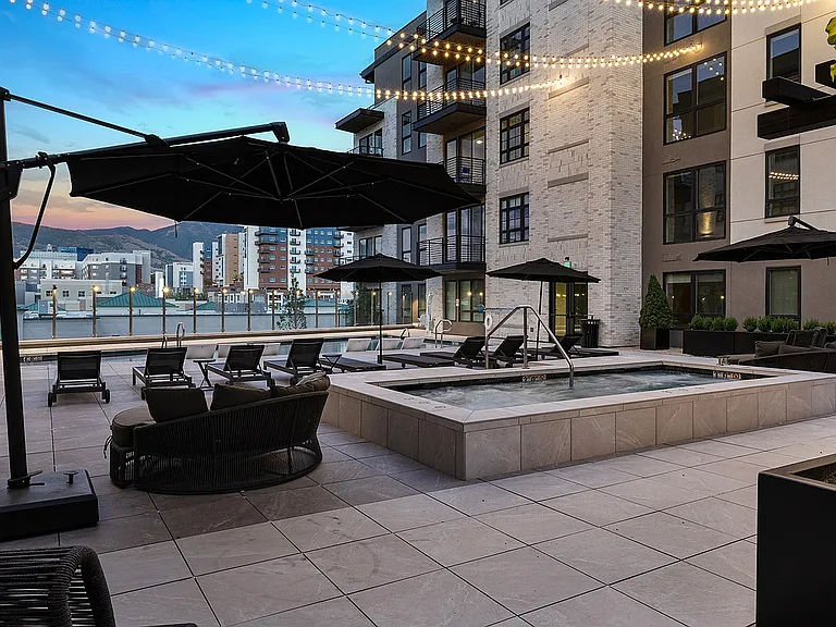 Evening view of the rooftop pool and hot tub with mountain backdrop