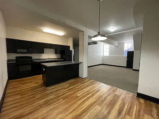 Kitchen with black appliances at 3 Points Loft.