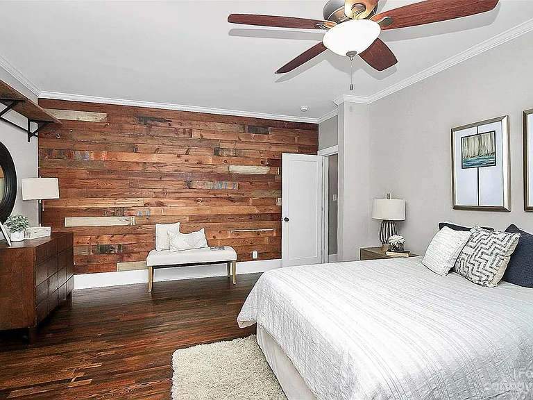 massive master bedroom with shiplap accent wall