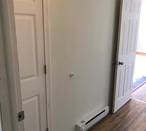 Hallway and closet leading to first floor bedroom