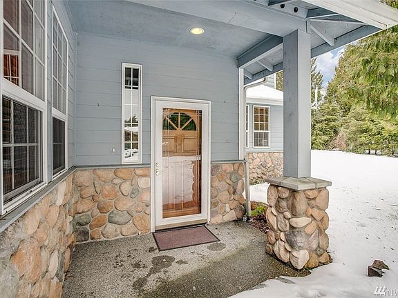 The stone entrance details and covered porch welcome you home.