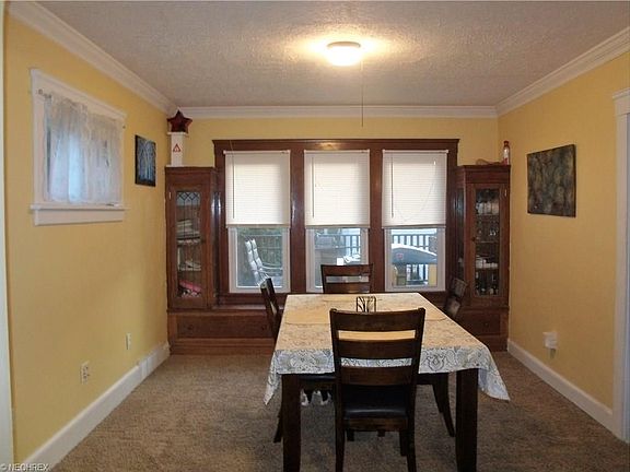Nice sized formal dining room features natural wood built-in china cabinets with leaded-glass as well as a window seat with storage.