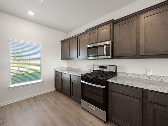 The kitchen of the Sterling has beautiful wood cabinetry.