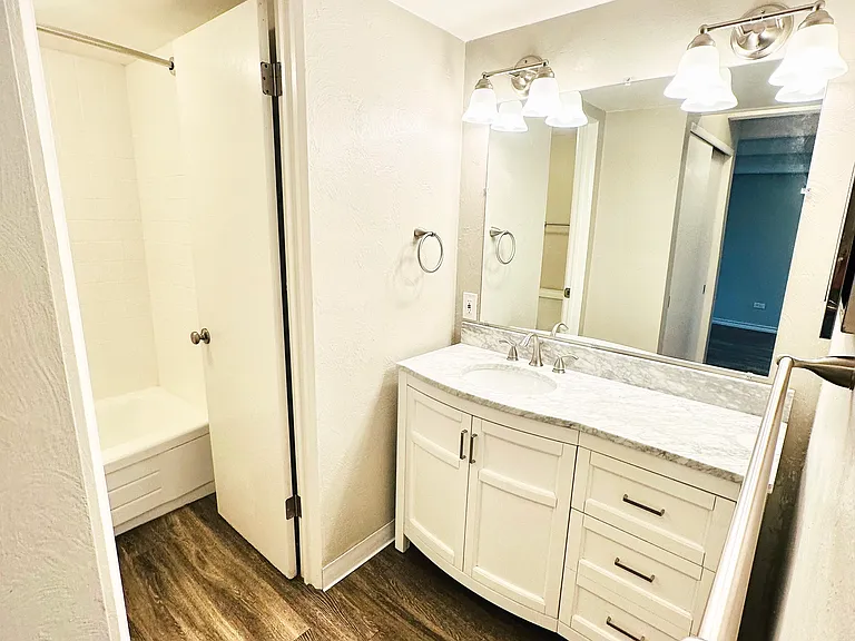 Step into this sleek bathroom featuring stylish cabinetry and ambient lighting. Step into this sleek bathroom featuring stylish cabinetry and ambient lighting.