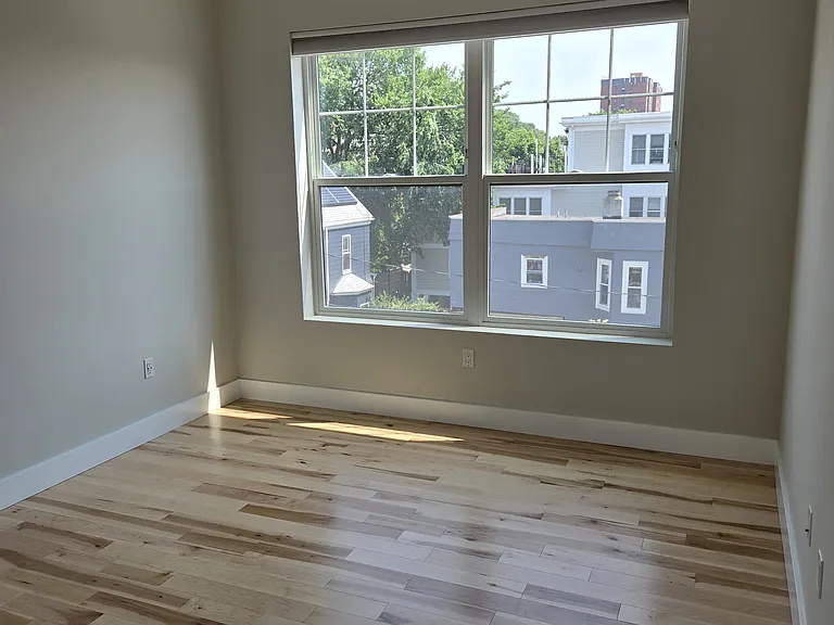 Primary bedroom with new wood floors (current photo).