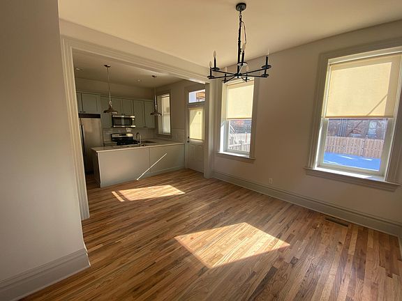Dining room looking toward kitchen and backyard. New windows, replicated historic trim, new electrical. Window shades. New hardwood oak floors on first floor. Restored pine floors on the 2nd floor.