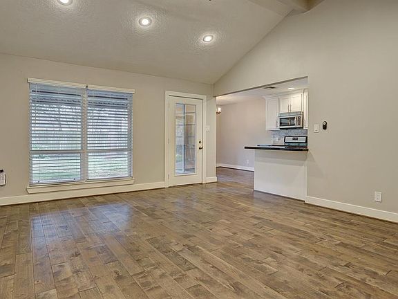 Large family room off the kitchen with high ceilings.