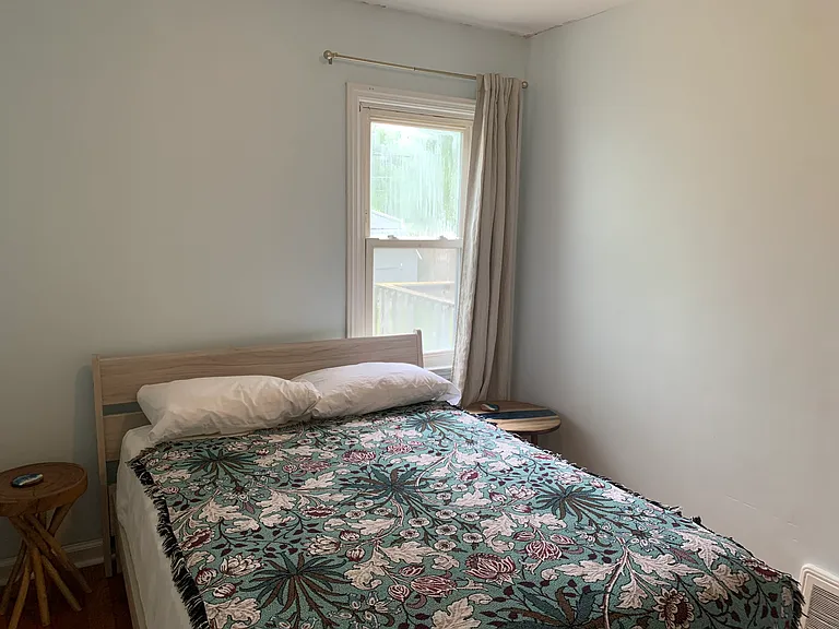 Second bedroom, also with natural light and natural hardwood floors.