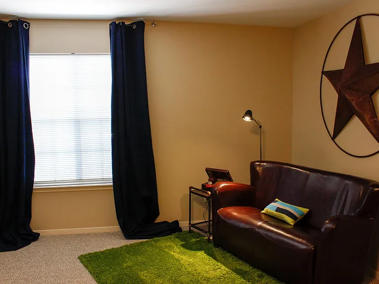 Very comfortable leather loveseat and reading lamp in the sitting area.