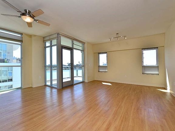 Spacious and bright living area surrounded by floor-to-ceiling windows.