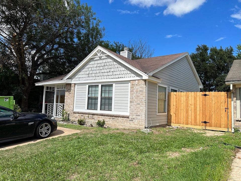 Front of home. Notice fresh paint, new fence, new porch railings
