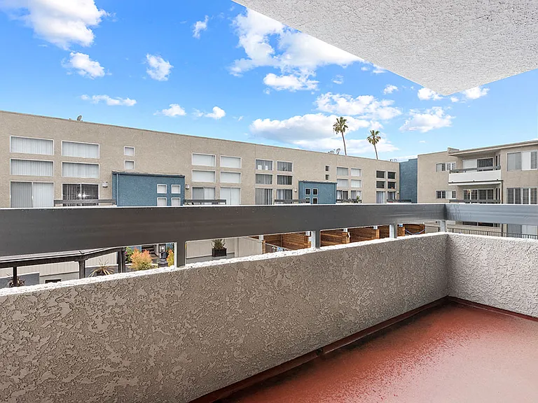 Covered balcony view of Hughes Regency courtyard.