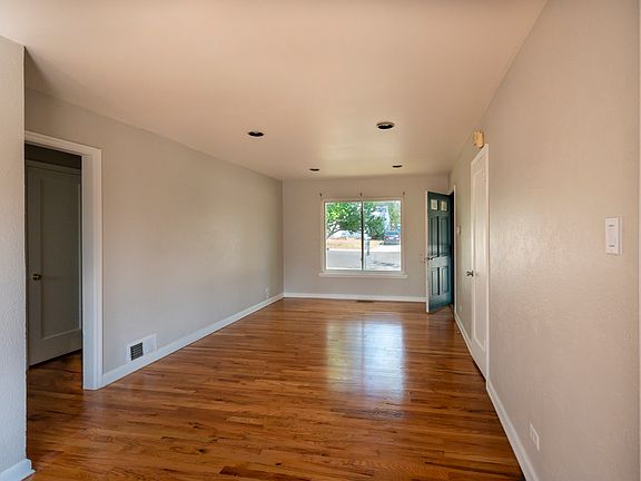 Open living / dining room. Windows and doors east and west. Lots of light.
