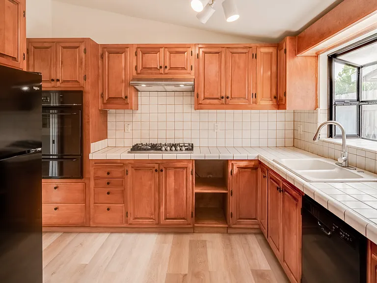LOTS OF STORAGE and counter space in kitchen! New cooktop, hood, and microwave. Garden window above sink for plants.