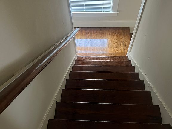Stairs descending to landing near entrance